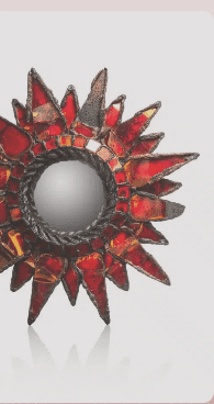 “Specchio decorativo a forma di sole con schegge di vetro colorato rosso e cornice in metallo nero”